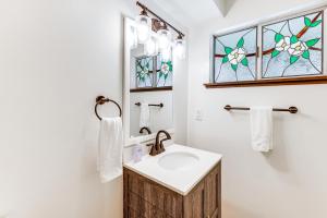 a bathroom with a sink and a stained glass window at Private Hot Tub at Dog-Friendly Lake Arrowhead Gem in Lake Arrowhead +22 photos