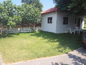 a small white house with a grass yard at Anastasia in Leptokarya