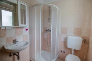 a bathroom with a shower and a toilet and a sink at Holiday Home Mia in Labin +7 photos