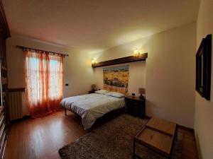 a bedroom with a bed and a large window at Passione Peonie Apartment in Roccabruna