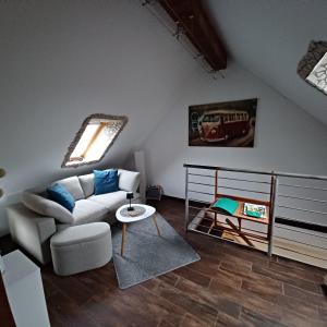 a living room with a couch and a table at Schulzis Ferienwohnung in Windeck