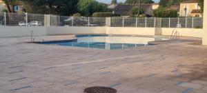 a swimming pool in the middle of a patio at Bastidon l'Arc en ciel in Fréjus +9 photos