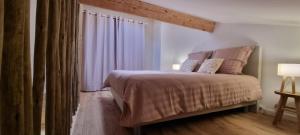 a bedroom with a large bed and a window at Bastidon l'Arc en ciel in Fréjus