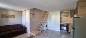 a living room with a staircase in a tiny house at Bastidon l'Arc en ciel in Fréjus