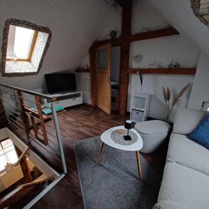 a living room with a couch and a table at Schulzis Ferienwohnung in Windeck