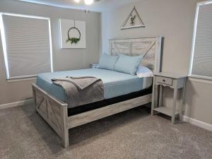 a bedroom with a bed and a table and windows at The Loft 1335 Whitt Ln in Clarksville