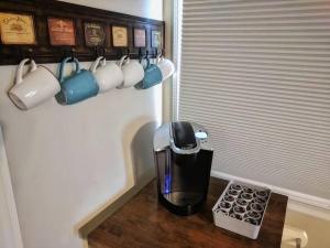 a coffee maker sitting on a table with coffee cups at The Loft 1335 Whitt Ln in Clarksville +27 photos