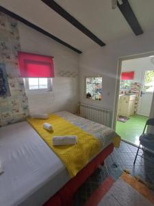 a bedroom with a bed with two towels on it at Sweet Home in Valjevo