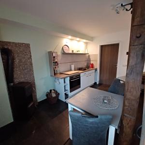 a small kitchen with a table and a counter top at Schulzis Ferienwohnung in Windeck +8 photos