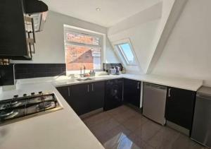 a small kitchen with a sink and a window at 2 bedroom Flat in Camden in London