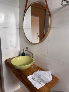 a bathroom with a green bowl sink and a mirror at Chalés da Chapada in Carolina +60 photos
