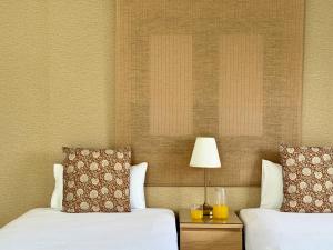 a bedroom with two beds and a table with a lamp at Canaryislandshost I Azucena in Tías