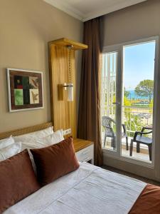 a hotel room with a bed and a balcony at MOY Beldibi Hotel in Antalya +76 photos
