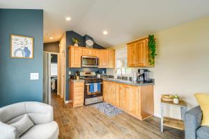 a kitchen with wooden cabinets and a stove top oven at 11 Mi to Port Townsend Ferry Cottage with View! in Port Hadlock