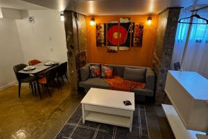 a living room with a couch and a table at Main Street Suites Nanton in Nanton