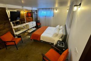 a small bedroom with a bed and a mirror at Main Street Suites Nanton in Nanton