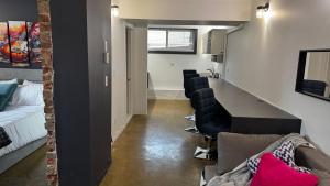 a room with a long table and chairs in it at Main Street Suites Nanton in Nanton