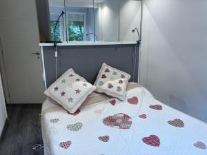a bed with two pillows on it in a bedroom at Navacerrada, Peace and Pool in Navacerrada +4 photos