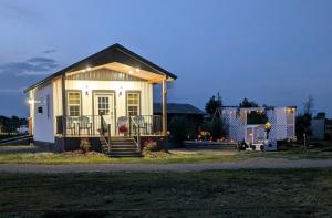 a small house with a porch and lights on it at Granny Zola's Hideaway Bed & Breakfast in Saint Anthony