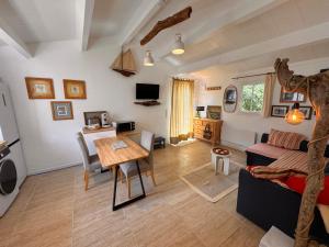 a living room with a couch and a table at Coup de cœur ! Maisonnette neuve à 300 m du port et de la plage in L'Ile d'Yeu