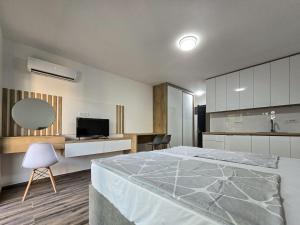a bedroom with a large bed and a kitchen at ND Apartments in Bar
