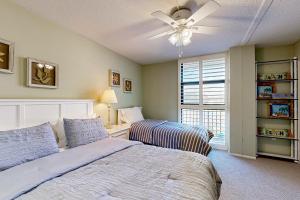 a bedroom with a bed and a ceiling fan at Sea Colony - 304 Brandywine House in Bethany Beach +42 photos