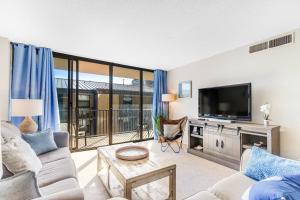 a living room with a couch and a tv at Sea Colony - 206 Brandywine House Rd in Bethany Beach