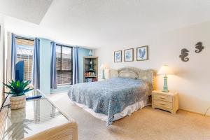 a bedroom with a bed with a blue blanket at Sea Colony - 206 Brandywine House Rd in Bethany Beach +43 photos