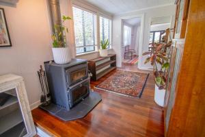 a living room with a wood burning stove in it at Bylund Cottage in Albany
