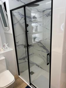 a glass shower in a bathroom with a toilet at Le bateau immobile in Salou +9 photos
