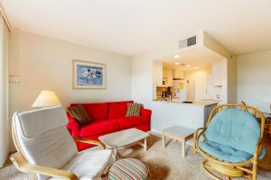 a living room with a red couch and chairs at Sea Colony - 203 Brandywine House Rd in Bethany Beach