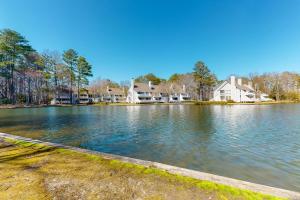 a view of a lake with houses in the background at Sea Colony - 203 Brandywine House Rd in Bethany Beach