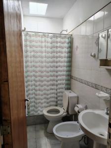 a bathroom with a toilet and a sink at Departamento Plaza España in San Rafael +11 photos