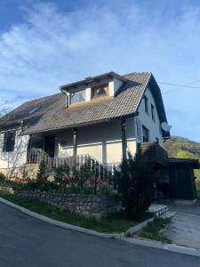 a white house with a gambrel roof at Apartment Mila in Plitvička Jezera