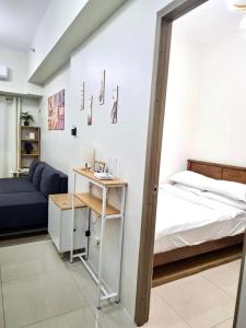 a room with a bed and a table and a bed and a couch at Cozy and Aesthetic Unit near to NAIA Airport Y&N Staycation in Manila