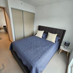 雅科A short walk from the sea - 2 bedrooms - 2 beds - 2 bathrooms的卧室里有一张大床，床单和枕头都是蓝色的 更多5张照片