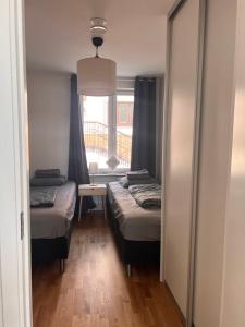 a small room with two beds and a window at Beautiful Apartment with a Loft in Lomma