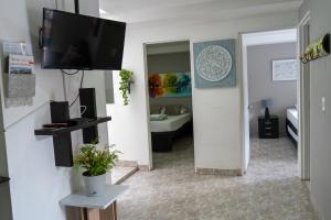 a living room with a flat screen tv on a wall at Apartamento Parque de Guatapé in Guatapé