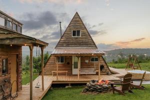 a small house with a roof on a wooden deck at Rustic Escape UTV, Tub, Trails & Fire Pit 25 acre in Roscoe