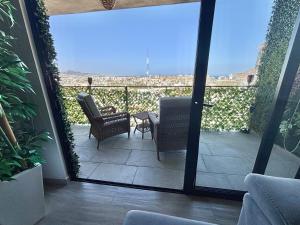 a patio with chairs and a table on a balcony at Apartment with Excellent Ocean View, Terra 194 in Cabo San Lucas