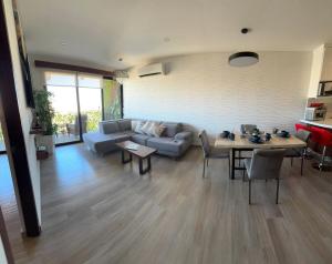a living room with a couch and a table at Apartment with Excellent Ocean View, Terra 194 in Cabo San Lucas