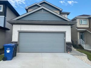 a garage door in front of a house at Jimmy in Winnipeg