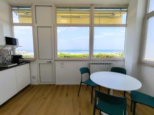 a room with a table and chairs and the ocean at Aqua Apartments in Francavilla al Mare +21 photos