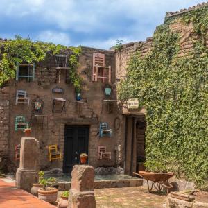 an old stone building with windows and ivy at Casa Trujillo in Capilla de Guadalupe