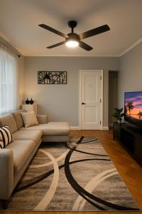 a living room with a couch and a ceiling fan at Spacious 4BR near NYC with Parking, 10min MetLife, 20min Times Sq in North Bergen