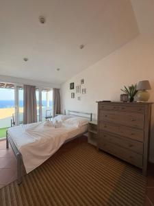 a bedroom with a bed and a dresser and a window at Apartment and Studio Ivan Dolac in Ivan Dolac