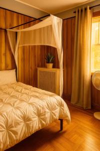 a bedroom with a canopy bed and a window at Spacious 4BR near NYC with Parking, 10min MetLife, 20min Times Sq in North Bergen