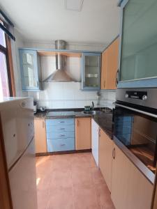 a kitchen with a sink and a stove at Casa Allariz in Allariz