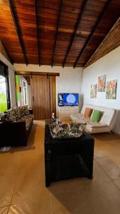 a living room with a couch and a tv at Finca Valparaíso in Sevilla +123 photos