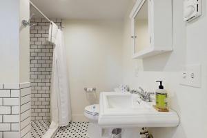 a white bathroom with a sink and a toilet at Bay Cottage in Boothbay Harbor +17 photos